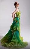 MNM Couture Style F02911 one-shoulder green gown with a draped bodice, floral appliqués at shoulder and hip, and a large pleated ombre ruffle train. | Couture Shop LA