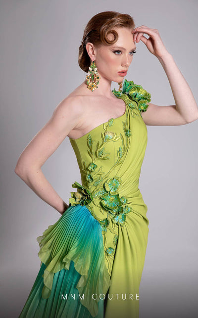 MNM Couture Style F02911 one-shoulder green gown with a draped bodice, floral appliqués at shoulder and hip, and a large pleated ombre ruffle train. | Couture Shop LA
