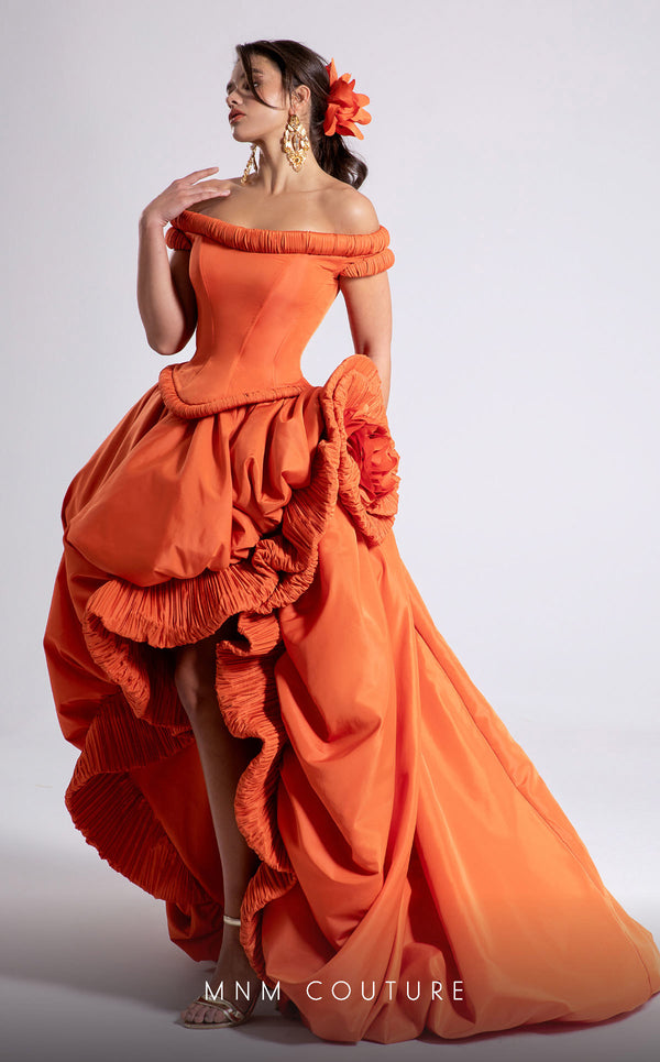 MNM Couture Style F02913 featuring an orange taffeta dress with off-shoulder cap sleeves, drapery on the neckline and waist, a high-low skirt with a cascading train, and a floral accent. | MNM Couture.