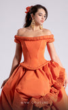 MNM Couture Style F02913 featuring an orange taffeta dress with off-shoulder cap sleeves, drapery on the neckline and waist, a high-low skirt with a cascading train, and a floral accent. | MNM Couture.