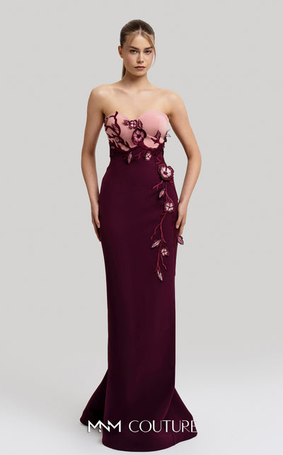 MNM Couture Style F02917 showing a fitted green column gown with a pink strapless bustier top, adorned with embroidered floral appliqués, and paired with a matching green cape. | Couture Shop LA
