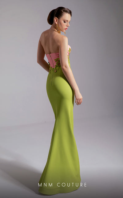 MNM Couture Style F02917 showing a fitted green column gown with a pink strapless bustier top, adorned with embroidered floral appliqués, and paired with a matching green cape. | Couture Shop LA