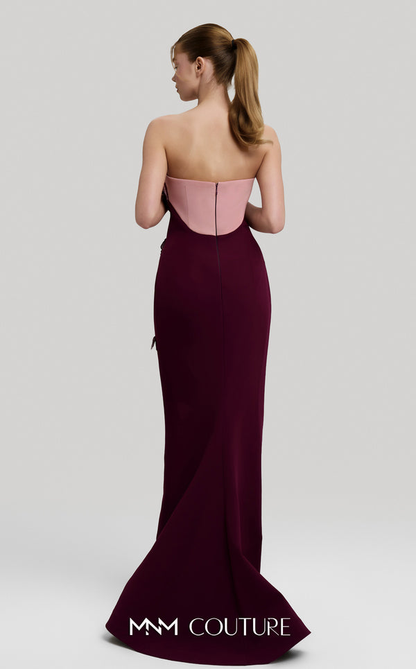 MNM Couture Style F02917 showing a fitted green column gown with a pink strapless bustier top, adorned with embroidered floral appliqués, and paired with a matching green cape. | Couture Shop LA