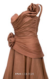 MNM Couture Style F02923 A-line gown featuring asymmetric neckline, fabric flower strap detail, pleated bust, and two floral accents at the waist | Couture Shop LA