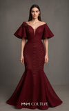 MNM Couture Style F02925 - Elegant black mesh mermaid gown featuring off-shoulder ruffled bell sleeves, a deep V-neckline, and a plumage brooch. | Couture Shop LA