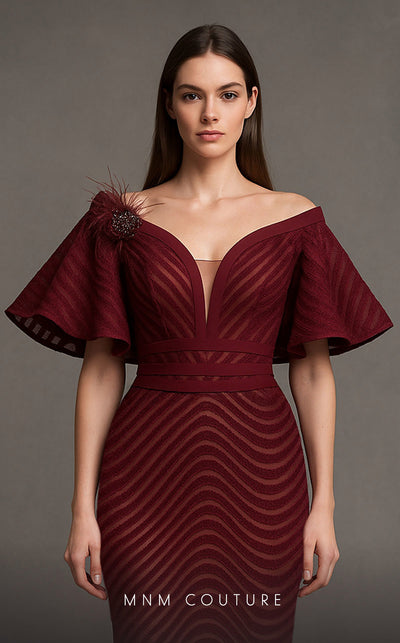 MNM Couture Style F02925 - Elegant black mesh mermaid gown featuring off-shoulder ruffled bell sleeves, a deep V-neckline, and a plumage brooch. | Couture Shop LA