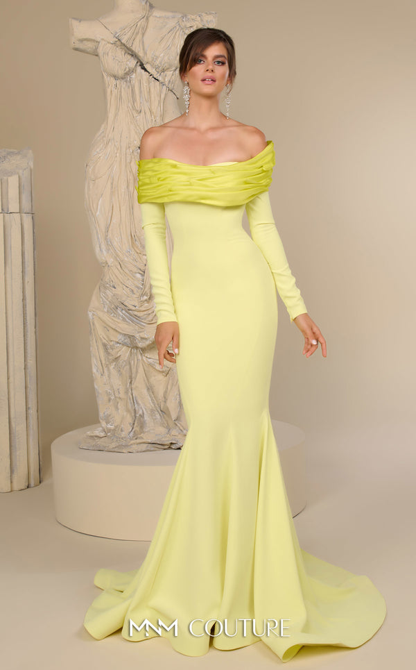 MNM Couture Style F02928 showcasing a dramatic mermaid silhouette dress in vibrant fuchsia, olive, or pink crepe, featuring pleated straight-across neckline, off-shoulder long sleeves, and a flowing train. | Couture Shop LA.
