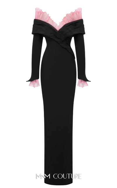 MNM Couture Style F02941 showing a black form-fitting evening gown with a pink off-the-shoulder ruffle detail, matching ruffled cuffs on the long sleeves, and a high back slit. | Couture Shop LA