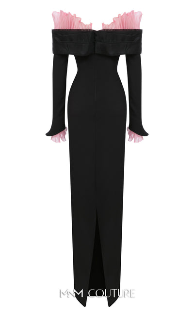 MNM Couture Style F02941 showing a black form-fitting evening gown with a pink off-the-shoulder ruffle detail, matching ruffled cuffs on the long sleeves, and a high back slit. | Couture Shop LA