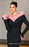 MNM Couture Style F02941 showing a black form-fitting evening gown with a pink off-the-shoulder ruffle detail, matching ruffled cuffs on the long sleeves, and a high back slit. | Couture Shop LA