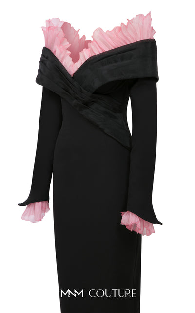 MNM Couture Style F02941 showing a black form-fitting evening gown with a pink off-the-shoulder ruffle detail, matching ruffled cuffs on the long sleeves, and a high back slit. | Couture Shop LA
