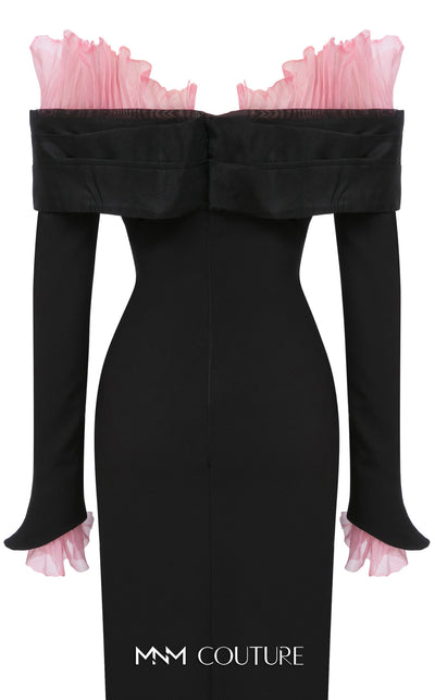 MNM Couture Style F02941 showing a black form-fitting evening gown with a pink off-the-shoulder ruffle detail, matching ruffled cuffs on the long sleeves, and a high back slit. | Couture Shop LA
