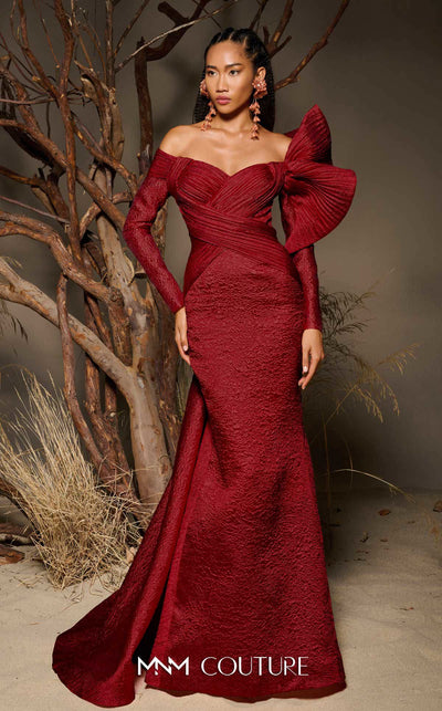 MNM Couture F02982 textured jacquard gown with off-the-shoulder long sleeves, pleated fans on the left shoulder, and a dramatic back train.|Couture Shop LA