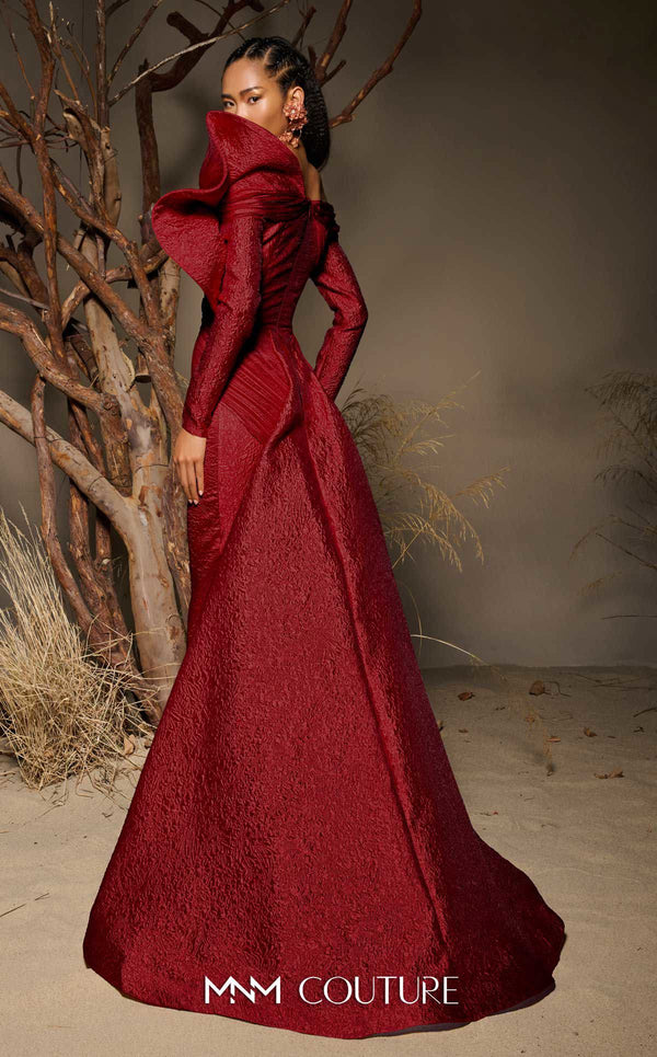 MNM Couture F02982 textured jacquard gown with off-the-shoulder long sleeves, pleated fans on the left shoulder, and a dramatic back train.|Couture Shop LA