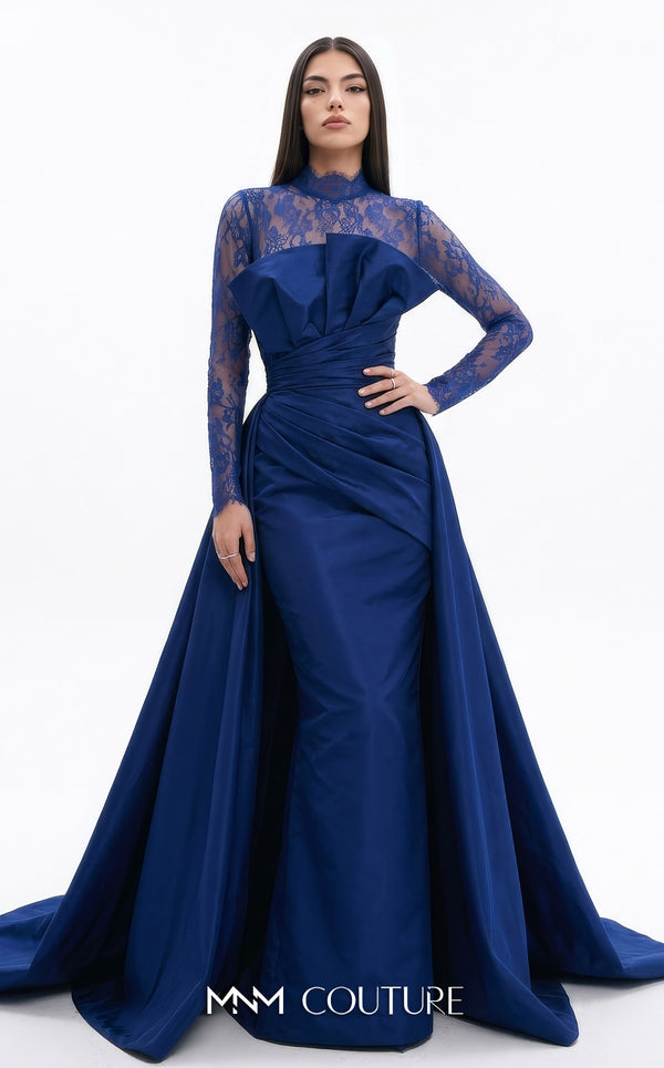 MNM Couture F03006A Chantilly lace and satin column gown featuring a high lace collar, sheer long sleeves, a 3D shoulder bow, an asymmetric ruched waist belt, stomach draping, and an open-front A-line overskirt | Couture Shop LA