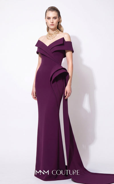 MNM Couture F03064 deep magenta crepe column gown with off-shoulder deep V cap bands, low open back, and oversized sculptural fin peplum at the left hip cascading into a side train | Couture Shop LA