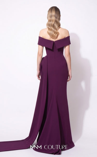 MNM Couture F03064 deep magenta crepe column gown with off-shoulder deep V cap bands, low open back, and oversized sculptural fin peplum at the left hip cascading into a side train | Couture Shop LA