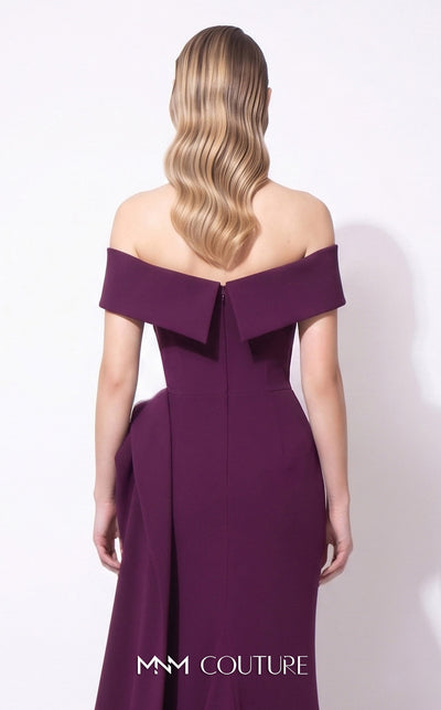 MNM Couture F03064 deep magenta crepe column gown with off-shoulder deep V cap bands, low open back, and oversized sculptural fin peplum at the left hip cascading into a side train | Couture Shop LA