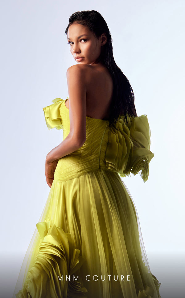 Green organza A-line evening gown with satin ruffles, structured corset bodice, and one off-the-shoulder sleeve highlighting MNM Couture Style G1736 | Couture Shop LA.