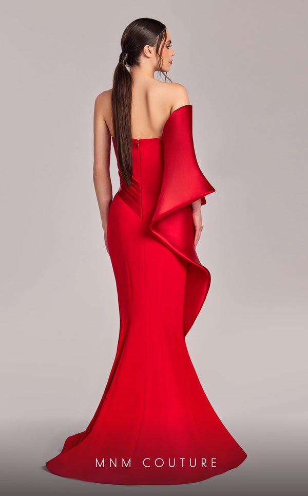 MNM Couture G1803 gown featuring a sleek mermaid silhouette, organza draping, and an exaggerated one-shoulder sleeve. | Couture Shop LA