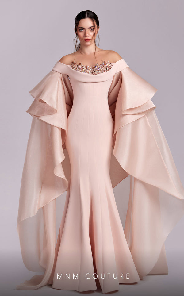 MNM Couture G1814 gown showcasing the luxurious crepe fabric and cascading sleeves. | Couture Shop LA