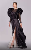 MNM Couture G1835 gown showcasing the dramatic ruffled shoulders and thigh-high slit.