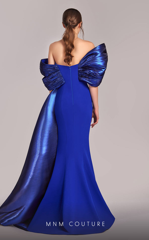 MNM Couture G1840 gown showcasing the elegant off-shoulder design and graceful mermaid skirt. | Couture Shop LA