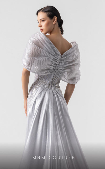MNM Couture G1939 silver lace gown with off-shoulder details and shimmering embellishments. | Couture Shop LA