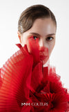 MNM Couture Style G2001 showcasing a red crepe evening gown with dramatic draped tulle bust, pleated organza detailing, and graceful trailing tulle train | Couture Shop LA
