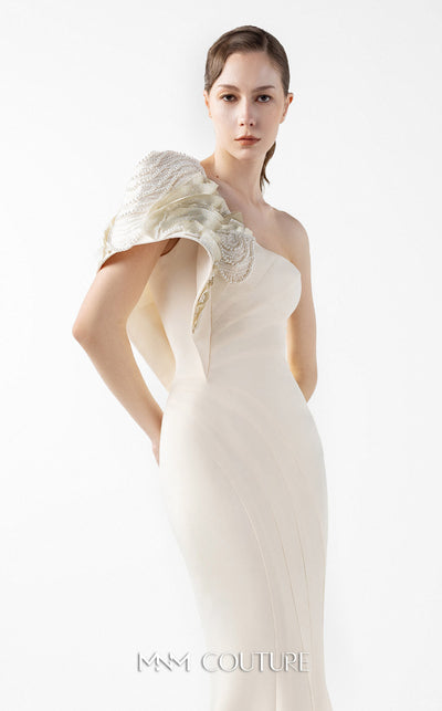 MNM Couture Style G2003 showcasing a cream one-shoulder mermaid gown with sculptural organza manipulation and cascading pearl embroidery on the shoulder. | Couture Shop LA