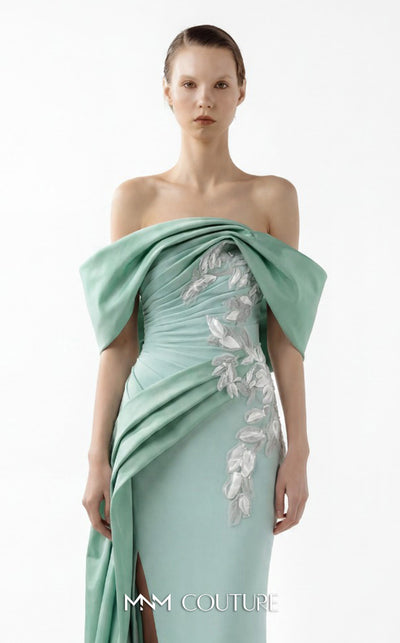MNM Couture Style G2007 showcasing a cream crepe gown with dramatic off-shoulder satin sleeves, exquisite handmade embroidery on the bodice, and subtle thigh-high slit | Couture Shop LA