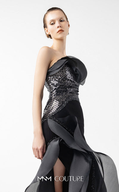 MNM Couture Style G2021 showcasing a strapless black gown with asymmetrical lace, flowing organza panels, and a dramatic high slit | Couture ShopLA.