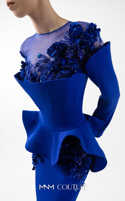 MNM Couture Style G2029 showcasing a royal blue mermaid crepe gown with illusion tulle neckline, intricate hand embroidery, long sleeves, and peplum waist detail | Couture Shop LA