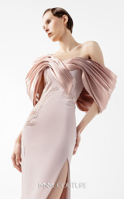 MNM Couture Style G2034 showcasing a salmon blush crepe gown with metallic off-shoulder neckline, delicate lace and tulle side embellishments, and a dramatic high slit | Couture Shop LA