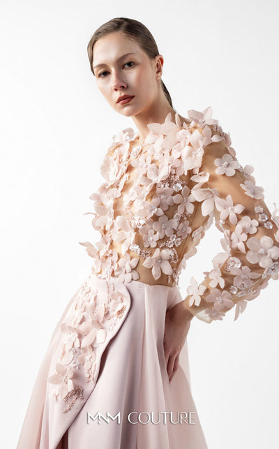 MNM Couture Style G2035 showcasing a blush pink gown with sheer illusion bodice, long sleeves adorned with 3D floral appliques, lace inserts, and flowing envelope skirt | Couture Shop LA