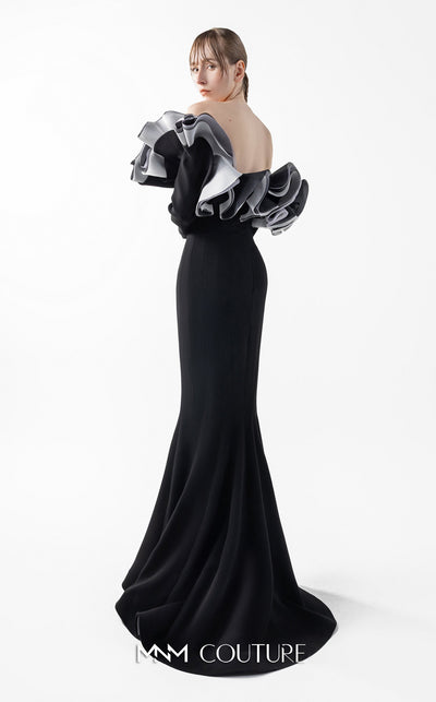 MNM Couture Style G2036 showcasing a black off-shoulder mermaid gown with long sleeves and voluminous, sculptural organza ruffles in silver, off-white, and anthracite. | Couture Shop LA