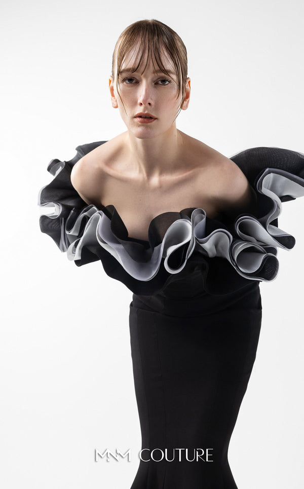 MNM Couture Style G2036 showcasing a black off-shoulder mermaid gown with long sleeves and voluminous, sculptural organza ruffles in silver, off-white, and anthracite. | Couture Shop LA