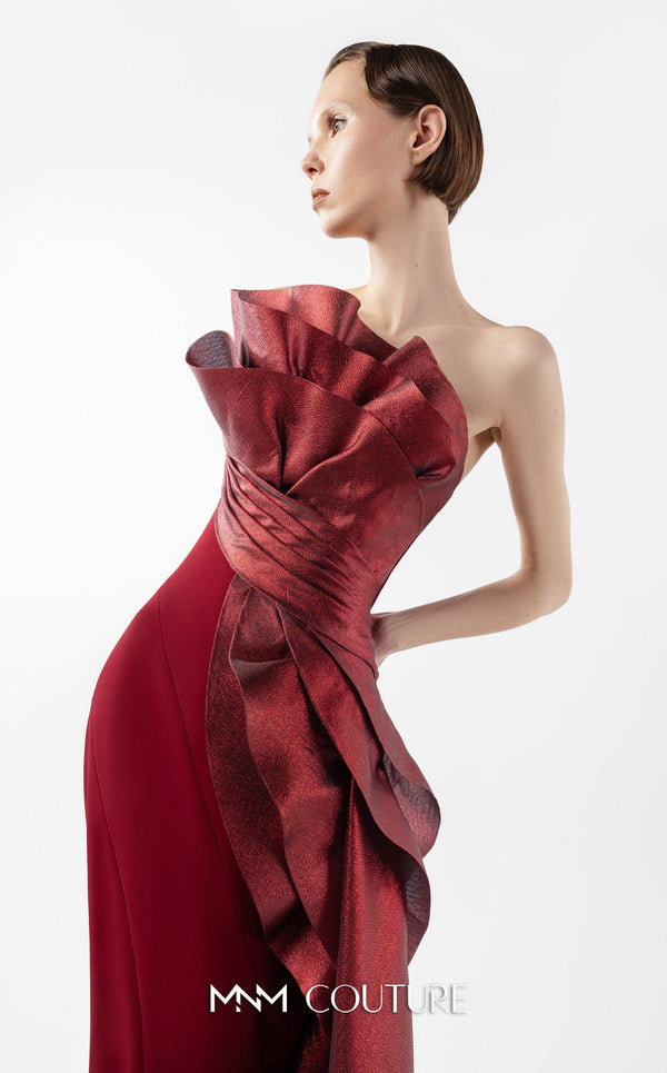 MNM Couture Style G2037 showcasing a strapless burgundy crepe gown with a sculpted, layered lamé organza bodice, a flowing train, and a high slit. | Couture Shop LA
