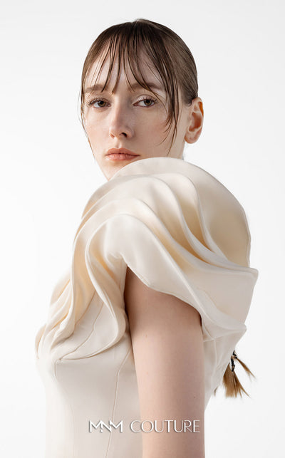 MNM Couture Style G2039 showcasing a cream mermaid gown with dramatic layered petal-like sleeves, sculptural shoulder detailing, and form-contouring silhouette with tonal paneling | Couture Shop LA