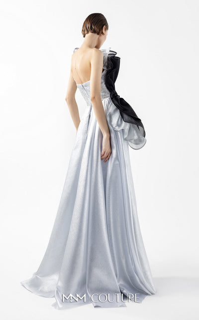 MNM Couture Style G2042 showcasing a silver lace gown with sculptural black and silver lamé organza ruffles, one-shoulder detail, and a high slit. | Couture Shop LA