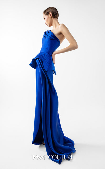MNM Couture Style G2044 showcasing a royal blue one-shoulder crepe gown with a structured peplum, folded organza drapes, a high slit, and a side train. | Couture Shop LA