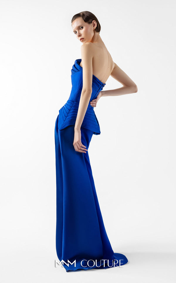 MNM Couture Style G2044 showcasing a royal blue one-shoulder crepe gown with a structured peplum, folded organza drapes, a high slit, and a side train. | Couture Shop LA