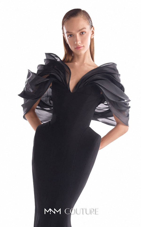 Black crepe mermaid gown MNM Couture Style G2110 with sculpted hips and voluminous blooming organza shoulders framing a V-neckline