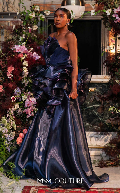 Strapless evening gown MNM Couture Style G2146 with cascading purple and navy fluid organza and a 3D floral waist bloom