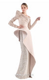 MNM Couture G2216 nude crepe and beaded sequin column gown with asymmetrical off-shoulder neckline, ruched long sleeves, architectural peplum, and beaded sequin panel | Couture Shop LA.