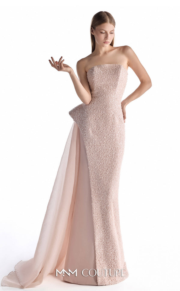 MNM Couture G2223 blush lace, crepe, and organza strapless column gown with intricate all-over embellishment, sculptural asymmetric peplum, and flowing organza overskirt with floor-length train | Couture Shop LA.