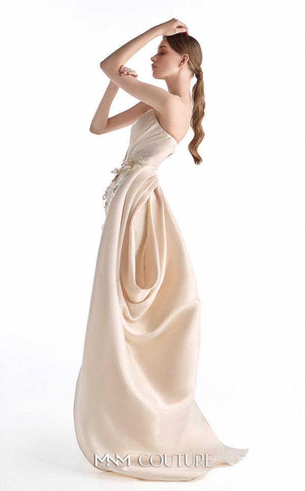 MNM Couture G2248 champagne crepe, lace, and crystal organza strapless column gown with sculpted bodice, hand-embroidered lace appliqués, draped crystal organza side panel, front slit, and sweeping train | Couture Shop LA.