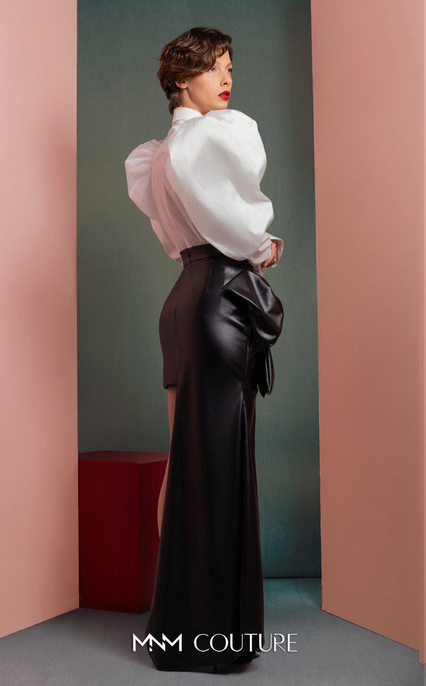 MNM Couture GOF2502 two-piece ensemble in coral mikado piqué, featuring a structured asymmetrical peplum blazer and matching high-waisted, wide-leg pants. | Couture Shop LA