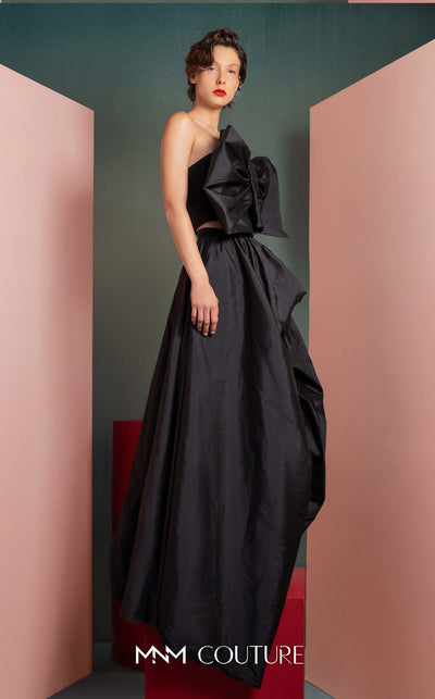 MNM Couture GOF2511 two-piece ensemble in black taffeta, featuring a sophisticated top with an oversized statement bow and a matching voluminous, floor-length skirt. | Couture Shop LA