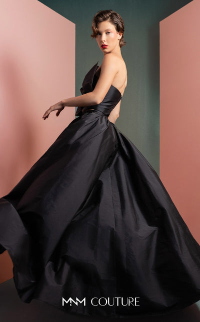 MNM Couture GOF2511 two-piece ensemble in black taffeta, featuring a sophisticated top with an oversized statement bow and a matching voluminous, floor-length skirt. | Couture Shop LA